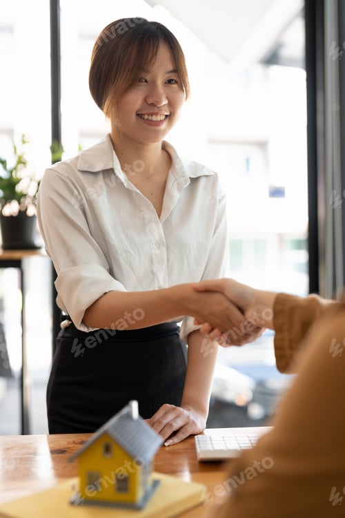 Preview: Successful agreement , estate,home buying contract concept, buyer shaking hand with bank empoyees