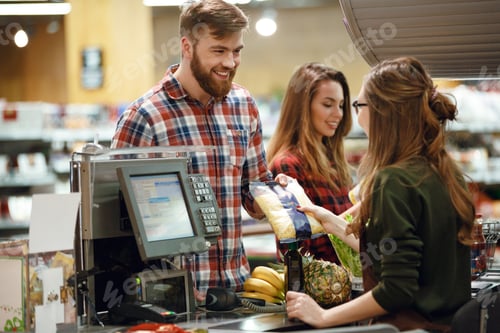 Preview: ?heerful young man standing in supermarket shop