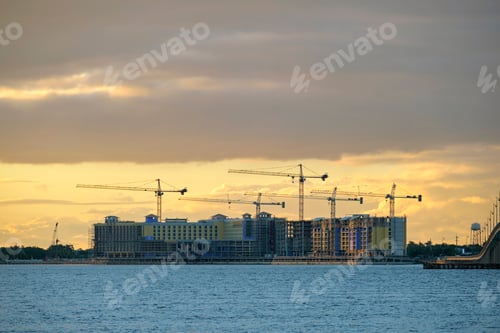 Preview: Tower lifting cranes at high residential apartment buildings construction site.