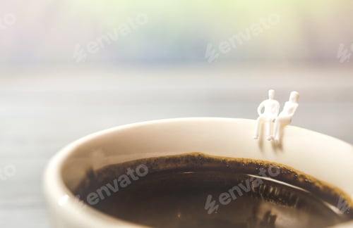 Preview: Miniature couple sitting on a cup of coffee