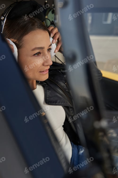 Preview: Concentrated lady in aviation headset keeping eyes on road