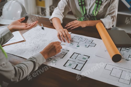 Preview: Architects reviewing house plans in a meeting