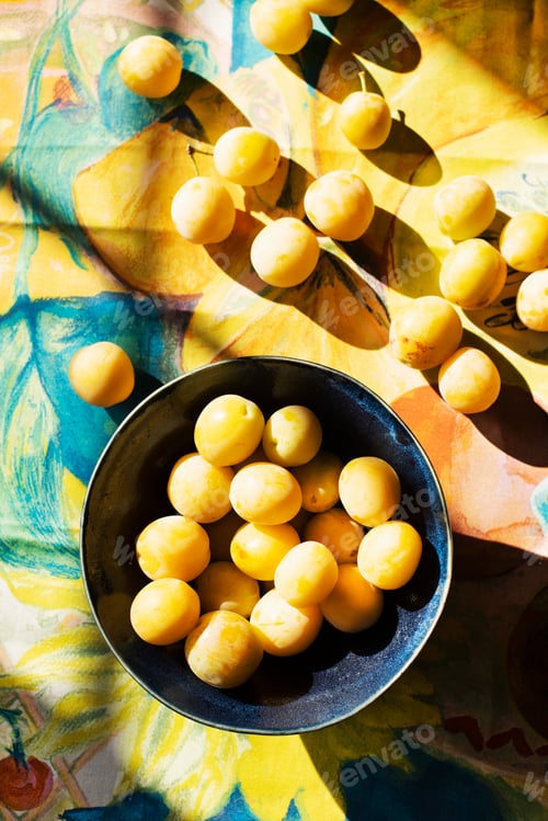 Preview: A sunny array of fresh lemons on a colorful tablecloth