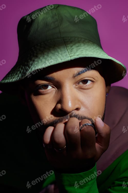 Preview: stylish good looking man in casual trendy outfit with rings looking at camera, fashion concept