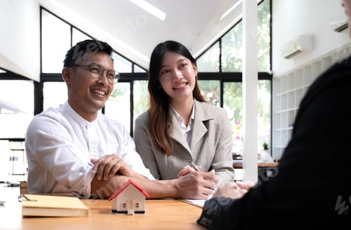 Preview: Horizontal view happy married couple wife asian ethnicity husband signing rental contract at meeting