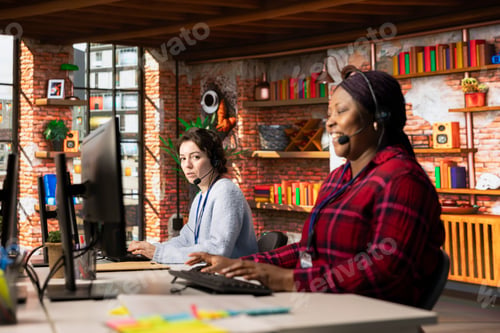 Preview: Call center agent laughing at funny joke while talking with customer in office