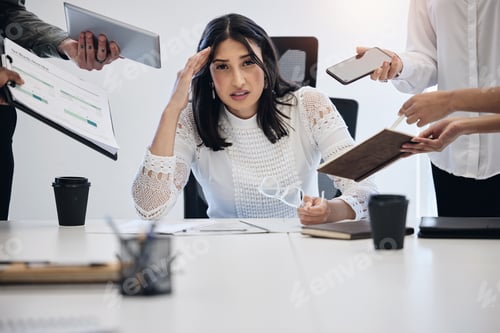 Preview: Shot of a young businesswoman looking stressed out in a demanding work environment