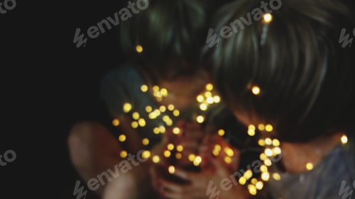 Preview: Reflected portrait of a woman holding christmas lights