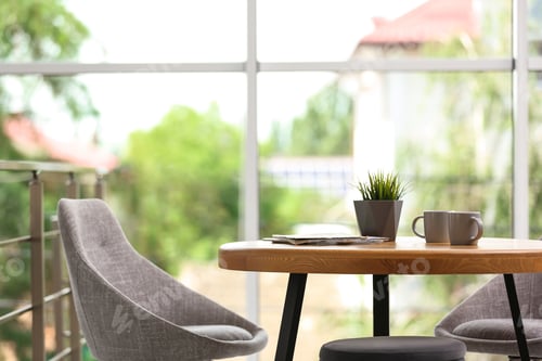 Preview: Stylish room interior with round table and comfortable chairs