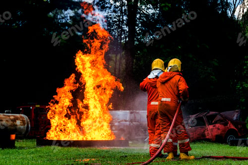 Preview: Firefighter Concept. Fireman using water and extinguisher to fighting with fire flame.