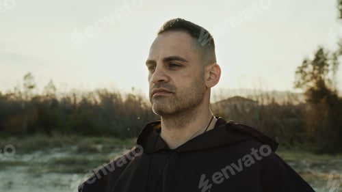 Preview: Religious Monk Wears His Hood And Prays In Nature At Sunset