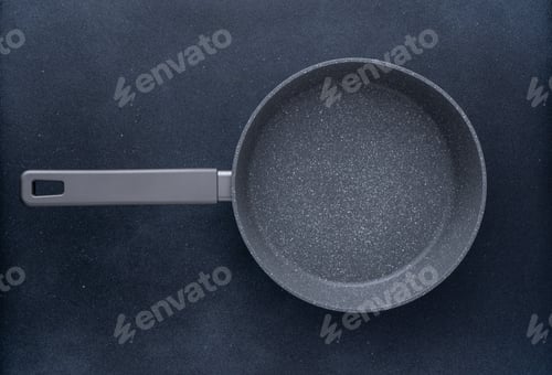 Preview: New granite frying pan on a gray background, top view. Empty fry pan with handle.