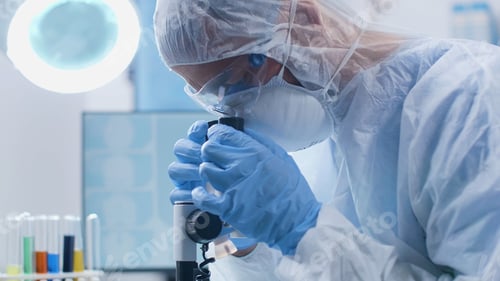 Preview: Scientist chemist looking into medical microscope analyzing dna sample