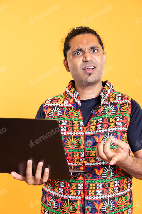 Preview: Portrait of man shocked after seeing error message on laptop screen
