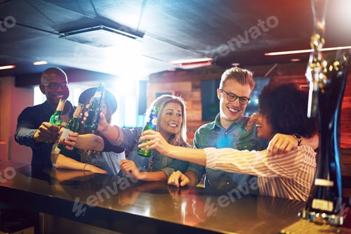 Preview: Friends gesturing cheers with beer at tavern