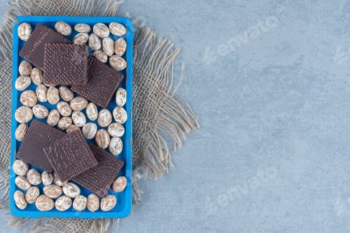 Preview: Waffles with cinnamon confectionery in the wooden tray, on the marble background