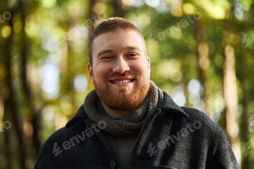 Preview: Portrait of Young Man Smiling Outdoors in Forest Setting