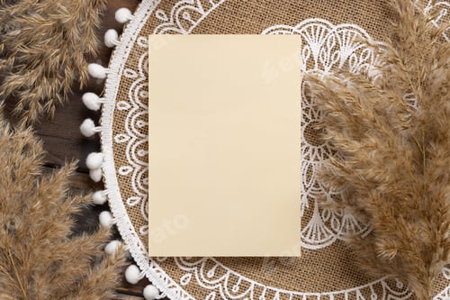 Preview: Blank card on bohemian placemat near pampas grass top view