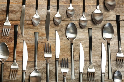 Preview: Forks, knives and spoons on wooden table, top view