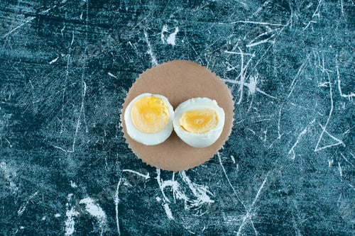 Preview: Boiled egg isolated on a wooden platter