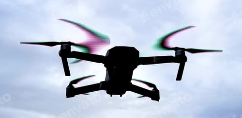 Preview: Backlit image of drone moving against a blue sky.
