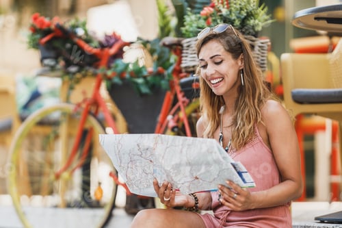Preview: Woman With A Map Exploring A Foreign City While Enjoying Summer Vacation