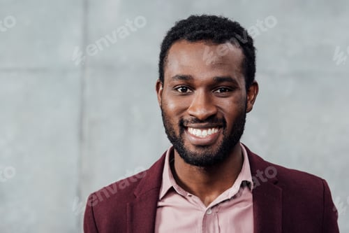 Preview: portrait of smiling african american casual businessman on grey background