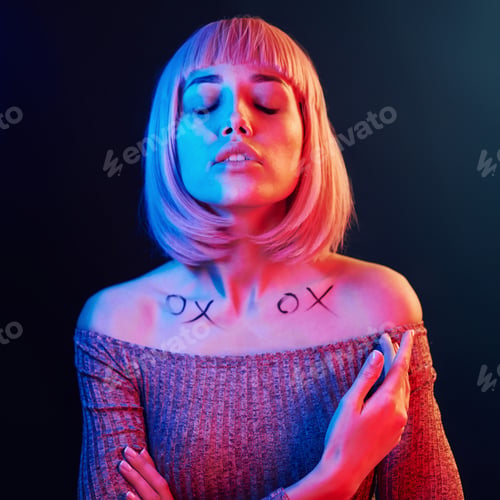 Preview: Portrait of young girl with blond hair in red and blue neon in studio