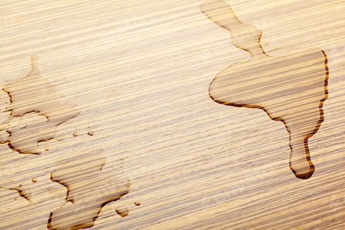 Water Droplets on a Light Brown Wooden Surface