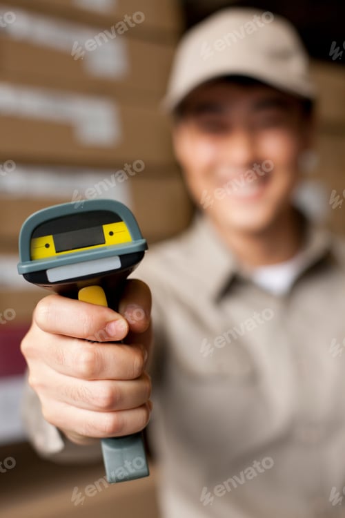 Preview: Male Chinese warehouse worker with scanner