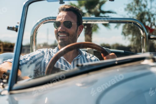 Preview: Man driving a convertible vintage car