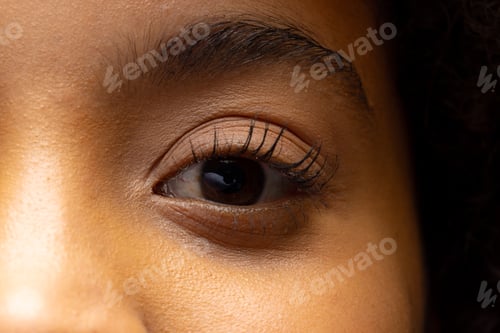 Preview: Close up of eye of biracial woman looking away
