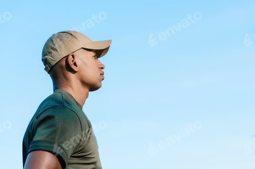 Preview: side view of african american soldier in cap against blue sky