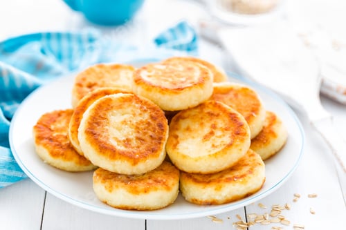 Preview: Cottage cheese pancakes with oats, syrniki on white rustic background