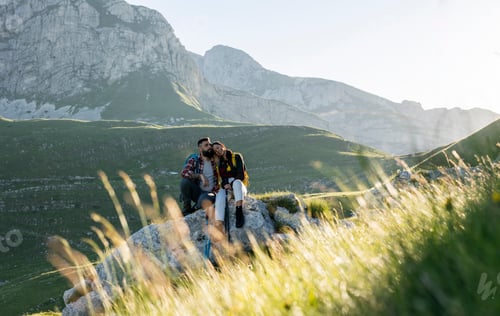 Preview: Couple Resting on a Rock During Mountain Hike