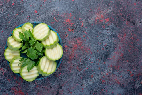Preview: Sliced zucchini with parsley in a blue platter
