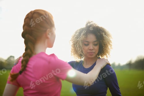 Preview: Two women exercising and stretching in the park