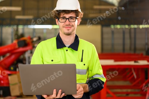 Preview: Portrait of happy male mechanical engineer in white hard hat and safety uniform