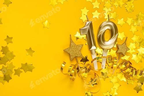 Preview: Gold candle in shape of number ten on yellow background surrounded by stars confetti and streamers.