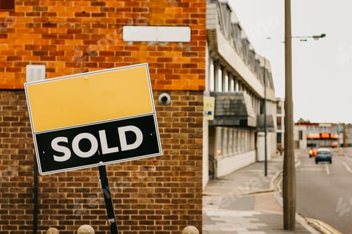 Preview: Sign on a brick wall with 'sold' written on it