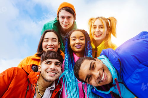 Preview: Multiracial group of young friends meeting outdoors in winter