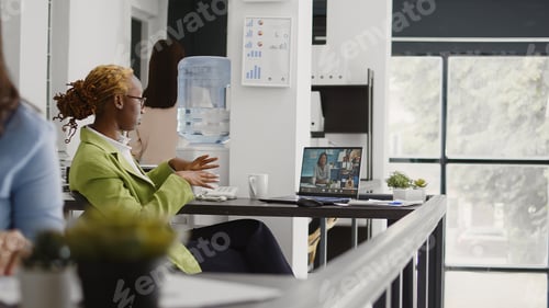 Preview: Office worker using online remote conference on webcam