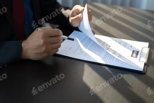 Preview: Employer in suit reading resume of job interview candidate profile collection.