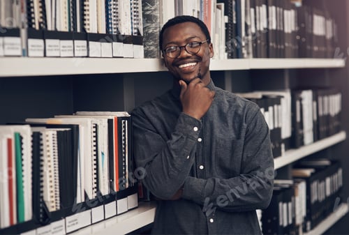 Preview: Cropped portrait of a handsome young male architect smiling while standing in a modern office
