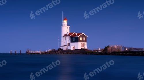 Preview: Paard van Marken, Netherlands. A lighthouse on the beach during blue hour.
