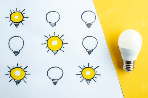 Preview: Top view of one real and drawings of many lighted switched off light bulbs on half white half
