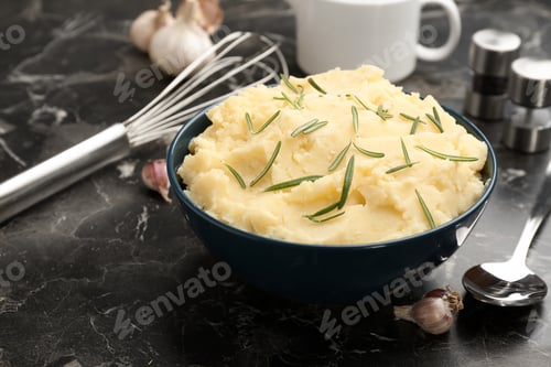 Preview: Bowl with tasty mashed potato on dark table