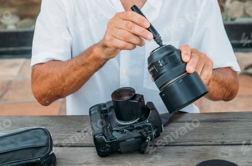 Preview: Close-up attractive white hair man repairing camera.