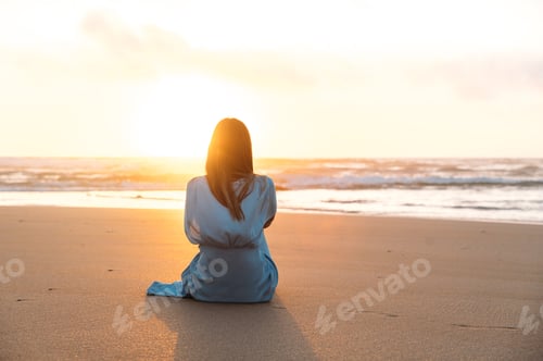 Preview: Unrecognizable woman admiring sea at sunset time
