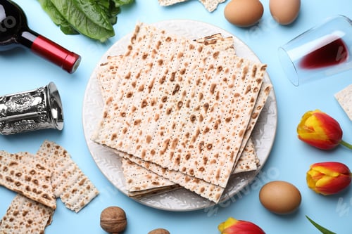 Preview: Flat lay composition with symbolic Pesach (Passover Seder) items on light blue background
